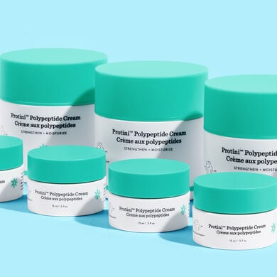 photo of Protini containers on a blue background. some are on their side, labels facing up and others have only the top showing
